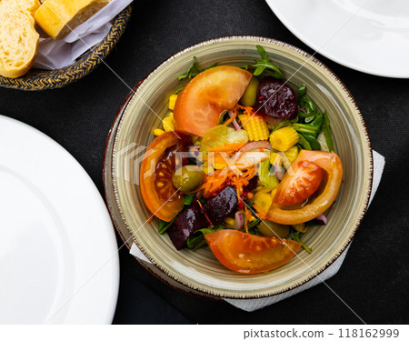 Tomatoes, corn, beetroot, lettuce salad served on table Tomatoes, corn, beetroot, lettuce salad served on table 118162999