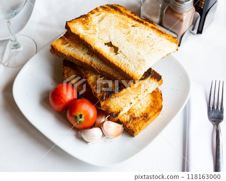 Traditional Catalan food, pan con tomate, served on plate Traditional Catalan food, pan con tomate, served on plate 118163000