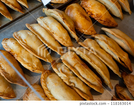 Rows of fresh, just baked empanadas 118163014