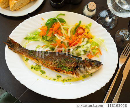 Grilled seabass with spicy herbal oil and fresh salad Grilled seabass with spicy herbal oil and fresh salad 118163028