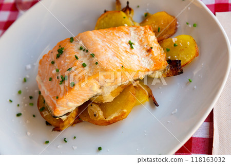 Deliciously steak of baked salmon with onion and potatoes Deliciously steak of baked salmon with onion and potatoes 118163032