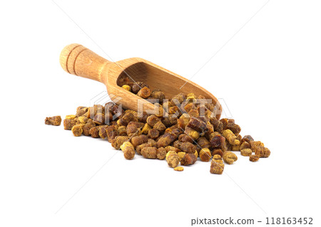 Wooden scoop filled with bee bread granules isolated on white background Wooden scoop filled with bee bread granules isolated on white background 118163452