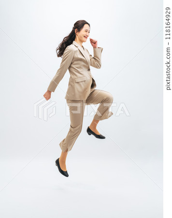 Full body photo of a jumping female business person 118164929