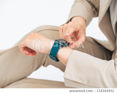 A woman using a smart watch 118164932