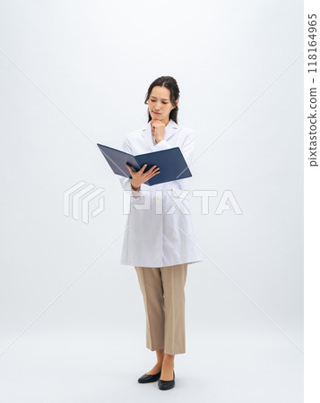 Full-body photo of a woman in a white coat looking at a file and thinking 118164965