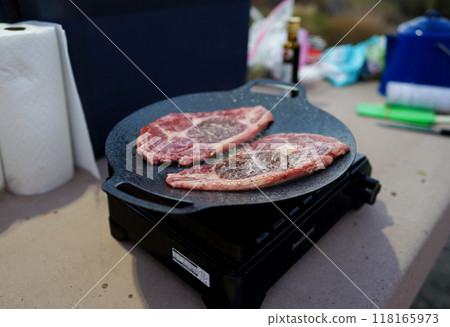 Camping steak grilled on a hot plate 118165973