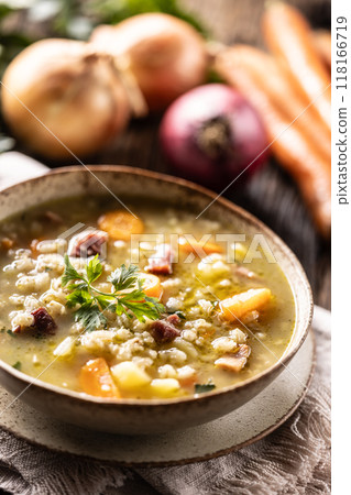 Soup made from barley groats, smoked pork neck, potatoes and root vegetables Soup made from barley groats, smoked pork neck, potatoes and root vegetables 118166719