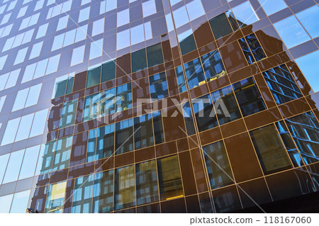 Close-up of modern glass office building with reflection in windows. Abstract urban pattern. Contemporary architectural design 118167060