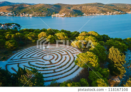 Panoramic view of islands in Adriatic Sea and hedge maze among forest trees at sunset. Lavender labyrinth in Rogoznica, Croatia. Aerial view of coastal landscape. Place for summer vacation 118167108
