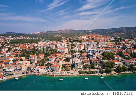 Aerial top view of seashore with turquoise water and coastal city with red-roofed houses. Panorama of tourist town Rogoznica in Croatia on Adriatic Sea. Summer vacation and travel concept Aerial top view of seashore with turquoise water and coastal city with red-roofed houses. Panorama of tourist town Rogoznica in Croatia on Adriatic Sea. Summer vacation and travel concept 118167131