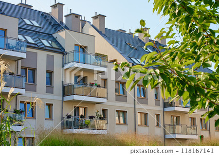 Residential building facade with balconies and windows. Modern city architecture. Apartment building exterior Residential building facade with balconies and windows. Modern city architecture. Apartment building exterior 118167141