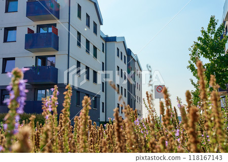Modern residential apartment building complex exterior with outdoor facilities on sunny summer day. Contemporary real estate architecture Modern residential apartment building complex exterior with outdoor facilities on sunny summer day. Contemporary real estate architecture 118167143