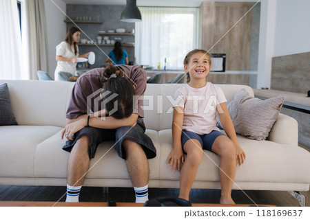 The older brother cringed a little at his younger sister's reaction to what he saw on TV. Awkward situation The older brother cringed a little at his younger sister's reaction to what he saw on TV. Awkward situation 118169637