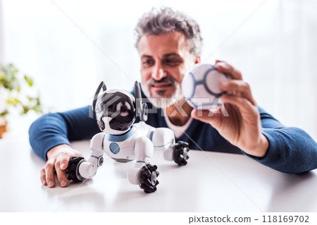 The man is looking at adorable robotic dog. The man is looking at adorable robotic dog. 118169702