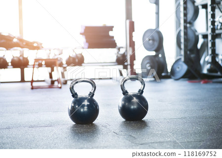 Kettlebells on floor in gym. Gym equipment for strength training. 118169752