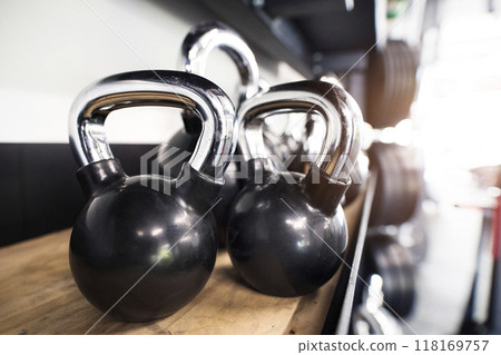 Kettlebells in racks. Gym equipment for strength training. 118169757