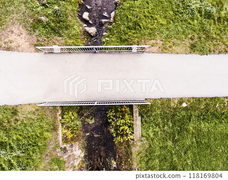 Aerial view of running path, jogging trail with bridge in the middle of park. Running training, no people. Aerial view of running path, jogging trail with bridge in the middle of park. Running training, no people. 118169804