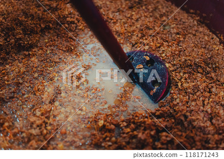 Punching down the cap, pigeage. Punching down the cap, pigeage. 118171243