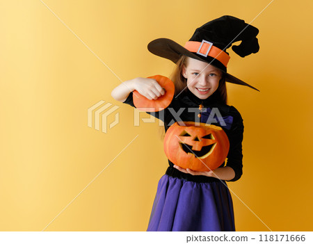 girl in witch costume with Halloween pumpkin girl in witch costume with Halloween pumpkin 118171666