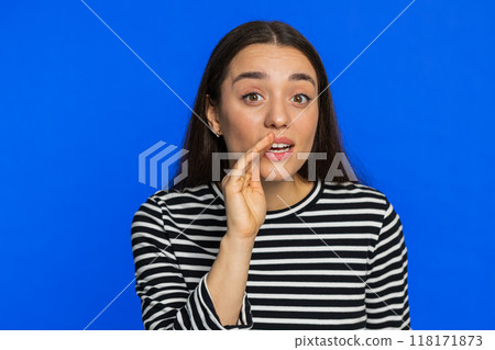 Young woman whisper news rumors holding hands near mouth, share gossip, quiet, keep my secrets Young woman whisper news rumors holding hands near mouth, share gossip, quiet, keep my secrets 118171873
