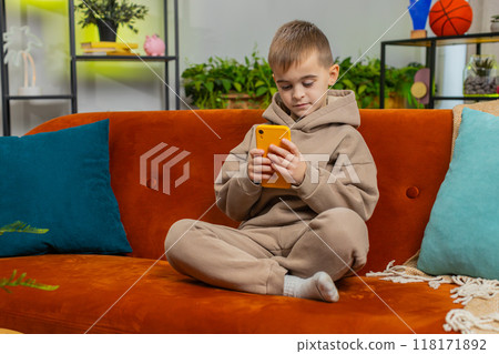 Young child kid boy texting share messages content on smartphone social media applications online 118171892