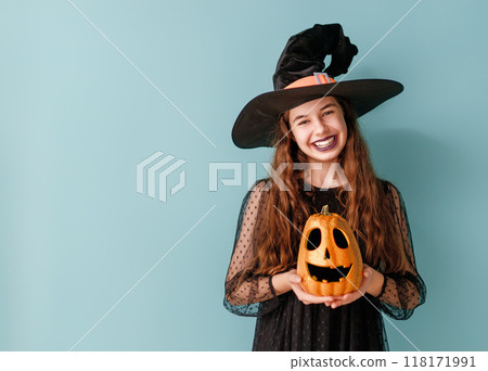 girl in witch costume with Halloween pumpkin girl in witch costume with Halloween pumpkin 118171991