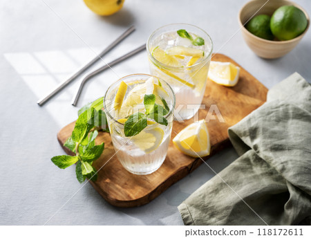 Lemonade drink with fresh lemons, lime, mint and ice. Refreshing citrus mojito cocktail  118172611