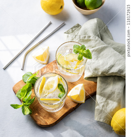 Lemonade drink with fresh lemons, lime, mint and ice. Refreshing citrus mojito cocktail  118172615