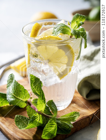 Lemonade drink with fresh lemons, lime, mint and ice close up.  118172617