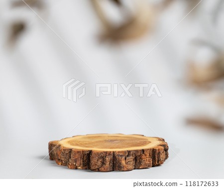 Abstract empty wooden podium with shadows and leaves on a gray background. Abstract empty wooden podium with shadows and leaves on a gray background. 118172633