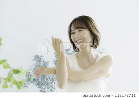 Middle-aged woman stretching indoors 118172711