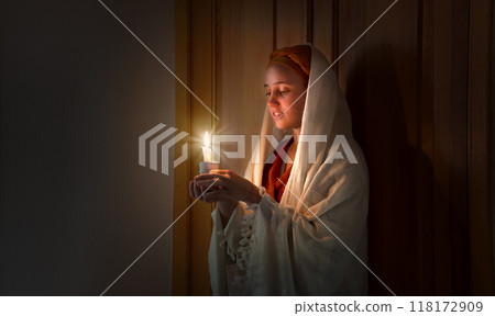 Young pretty girl with a candle 118172909