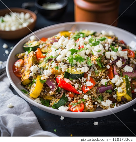 Single serving of quinoa salad with grilled vegetables and a sprinkle of feta cheese. 118173362