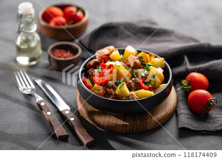 Fried pork meat with potatoes, onions and peppers. National homemade Georgian dish ojakhuri Fried pork meat with potatoes, onions and peppers. National homemade Georgian dish ojakhuri 118174409