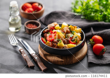 Fried pork meat with potatoes, onions and peppers. National homemade Georgian dish ojakhuri Fried pork meat with potatoes, onions and peppers. National homemade Georgian dish ojakhuri 118174411