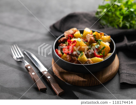 Fried pork meat with potatoes, onions and peppers. National homemade Georgian dish ojakhuri Fried pork meat with potatoes, onions and peppers. National homemade Georgian dish ojakhuri 118174414