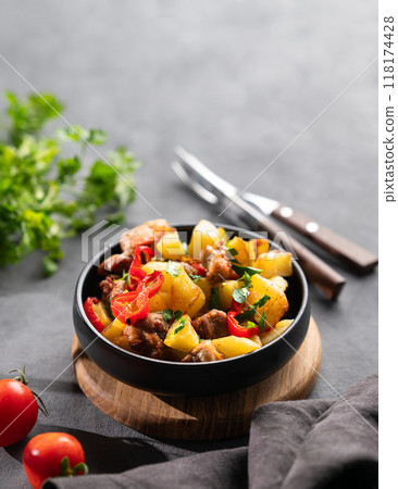 Fried pork meat with potatoes, onions and peppers. National homemade Georgian dish ojakhuri Fried pork meat with potatoes, onions and peppers. National homemade Georgian dish ojakhuri 118174428