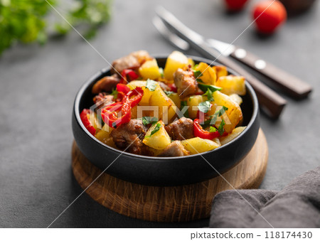 Fried pork meat with potatoes, onions and peppers. National homemade Georgian dish ojakhuri Fried pork meat with potatoes, onions and peppers. National homemade Georgian dish ojakhuri 118174430