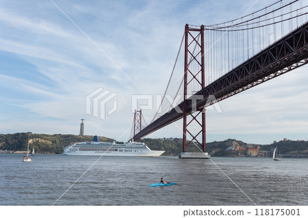 Cruise ship passing under the 25 de abril bridge in lisbon 118175001
