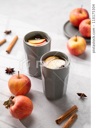 Homemade apple punch with apples and cinnamon in cups on a light background with fresh fruits Homemade apple punch with apples and cinnamon in cups on a light background with fresh fruits 118175304