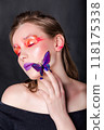 Woman with Butterfly Near Face 118175338