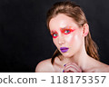 Young Woman with Artistic Makeup on Dark Background 118175357