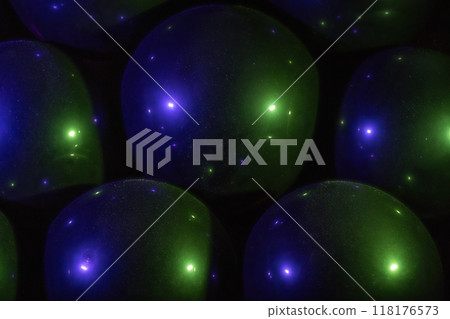 Black balloons with water drops in purple and green neon light Halloween party background 118176573