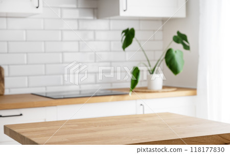 Wooden tabletop with free space for product montage or mockup against blurred white kitchen 118177830