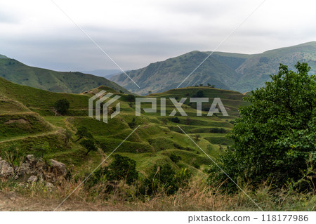 Chokhsky terraces Dagestan. Landscape of mountainous Dagestan with terraced fields and peaks mountains in the distance. Chokhsky terraces Dagestan. Landscape of mountainous Dagestan with terraced fields and peaks mountains in the distance. 118177986