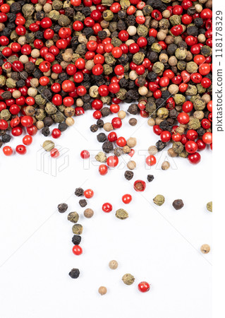 Red, green, white and black peppercorns on a white background top view. Red, green, white and black peppercorns on a white background top view. 118178329