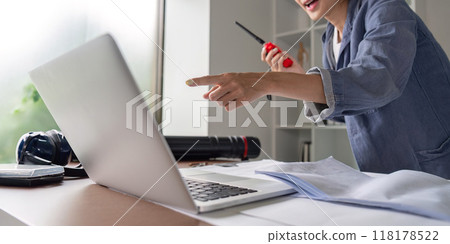 Engineer using walkie talkie during video call in office Engineer using walkie talkie during video call in office 118178522