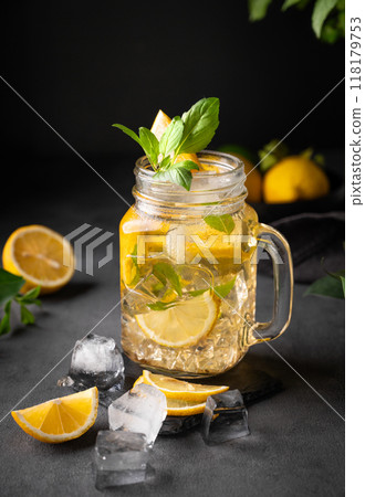 Lemonade drink with fresh lemon, mint and ice in jar. Refreshing citrus mojito cocktail or cold tea 118179753