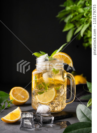 Lemonade drink with fresh lemon, mint and ice in jar. Refreshing citrus mojito cocktail or cold tea 118179755