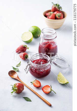 Homemade strawberry jam. Preserved food in a glass jar with fresh organic berries Homemade strawberry jam. Preserved food in a glass jar with fresh organic berries 118179775
